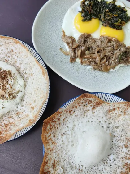A perfect Sunday breakfast featuring our Pandi Curry. It's served here with soft appams, fried eggs, and sautéed oyster mushrooms for a complete and hearty Kodava-style meal.