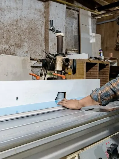 A craftsman at our factory uses specialized machinery for custom cuts and shapes. This capability allows us to create unique and tailored furniture solutions that fit your office space perfectly.