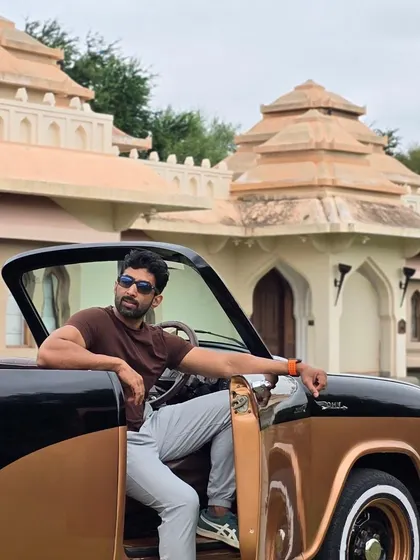 Posing with the vintage car at Evolve Back, Hampi. Sometimes the stay is as much a part of the heritage experience as the ruins themselves.