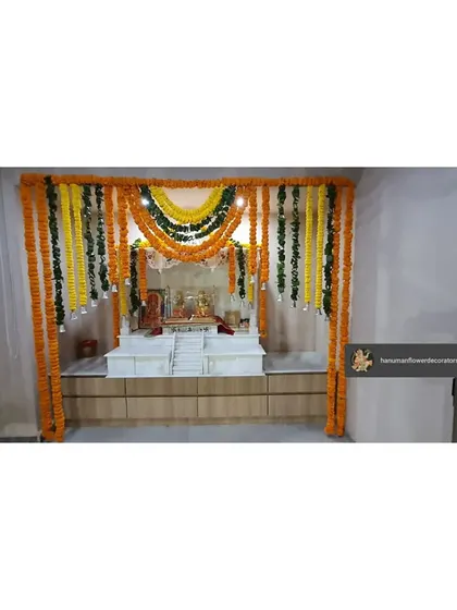 We created this traditional pooja space within an office using marigold and leaf garlands. The setup provides a serene and auspicious corner for prayers during festivals.