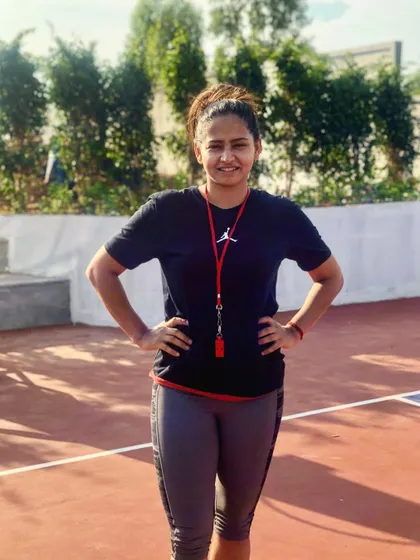 A portrait of our founder and coach, Akanksha Singh, on the court. Her passion and experience drive the academy's mission.