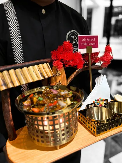 Our "Old School Chilli Paneer" is a timeless favorite with a classic kick. We serve it in a unique tabletop brazier to keep it warm, adding a touch of theatre to the presentation.