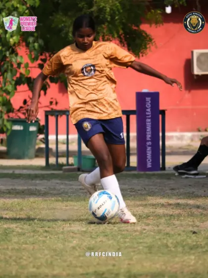 Our player skillfully dribbling the ball, demonstrating close control and balance during a match.