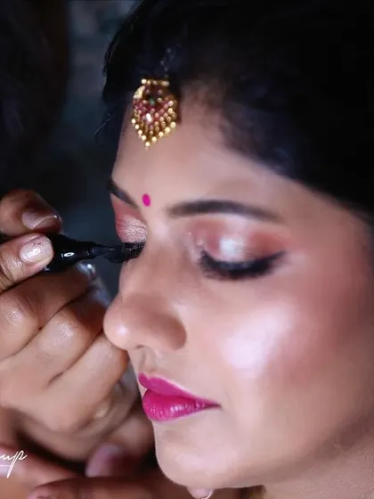 A glimpse into my process. Here, I am applying the final touches to the eyeliner, a crucial step in defining the eyes for a classic bridal look. I work meticulously to ensure every detail is perfect for my brides.