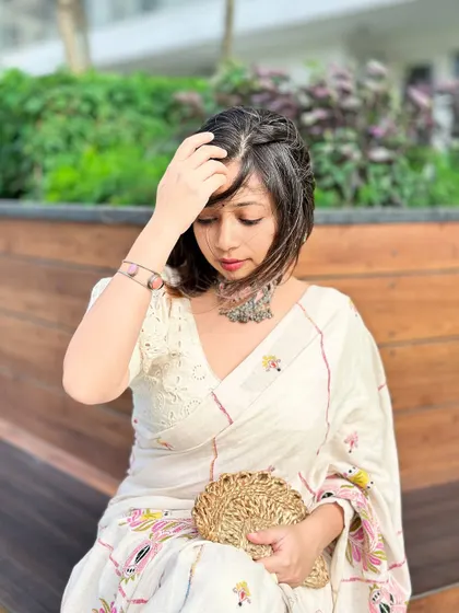 A quiet, introspective moment in a beautiful off-white kantha stitch saree. The silver choker adds a touch of bohemian elegance.
