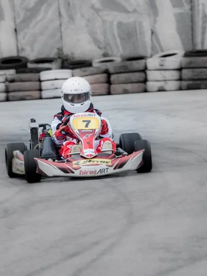 Our rookie driver in kart number 7 navigating a challenging section of the track. We support drivers at every level, from novice to seasoned professional.