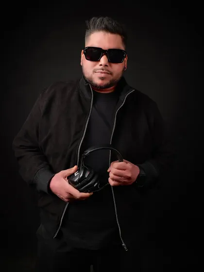 Holding my most important tool: the headphones. This is where the music begins.