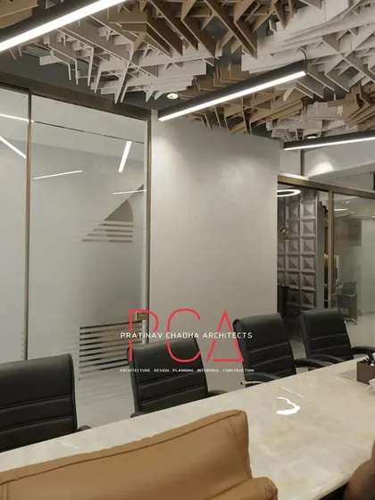 A view from the conference table at StyleIn Homes, looking out into the rest of the office, highlighting the layered design and use of transparent and translucent materials.