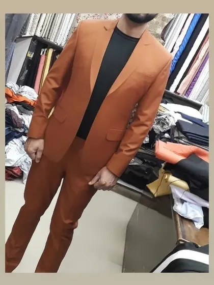 A two-piece suit in a modern rust color. This is a great alternative to traditional colors for making a style statement.