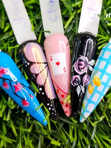 A sampler of different hand-painted styles, from a butterfly wing and playing card to floral patterns. This shows the wide range of creative possibilities.