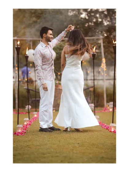 A romantic dance during a beautifully lit outdoor evening event.