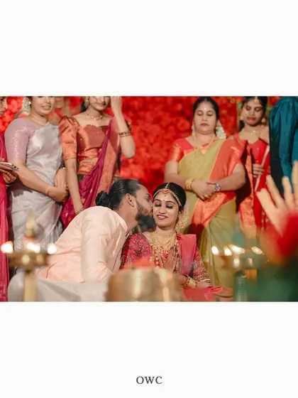A sweet kiss on the cheek from the groom to his bride during their wedding ceremony.