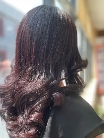 Another angle of the soft-curled hairstyle, showcasing the subtle layers and the way the light reflects off the healthy, styled hair.