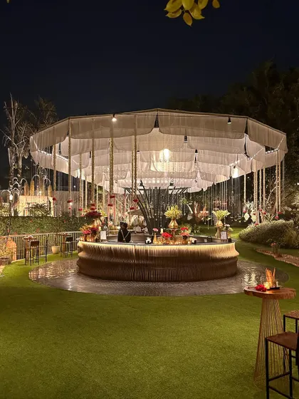 The circular bar at night, with its beautiful canopy, serving as a central feature of the lawn.