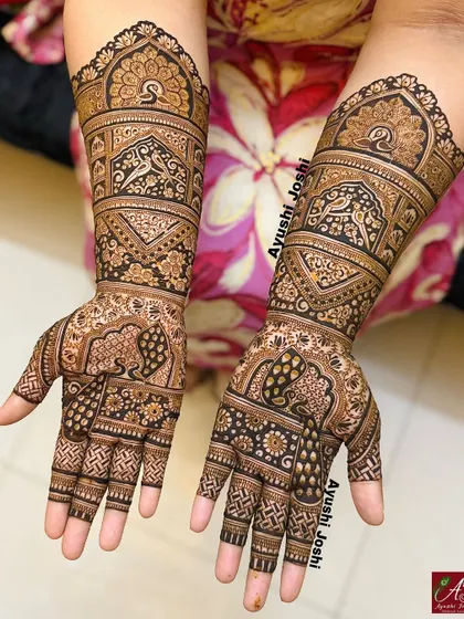 A full, two-hand design that celebrates tradition with a variety of patterns, including peacocks, elephants, and detailed grid work.
