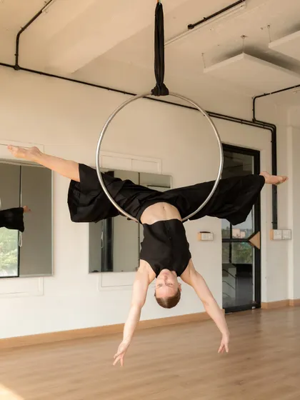 Holding a clean, strong split on the aerial hoop during a photoshoot. This pose showcases the balance between strength and flexibility that is at the core of my aerial practice.