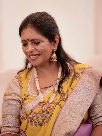 A smile is the best accessory, but a beautiful pearl necklace helps. This piece was designed to match the lavender tones in my saree.