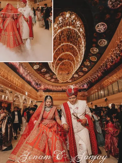 A grand, wide-angle shot of the bride and groom making their entrance into a magnificently decorated wedding hall. This photo captures the scale and splendor of the event.
