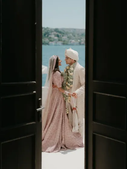 A stolen glance through a doorway in Turkey. This composition uses natural framing to create a sense of privacy and intimacy, as the couple shares a moment by the water, away from the world. It’s a quiet, observational style of destination wedding photography.