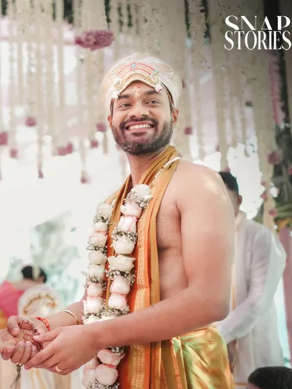 A smiling groom during his South Indian wedding ceremony. We ensure the groom's joy and personality are a central part of the wedding story.