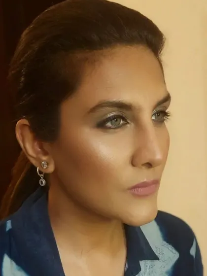 A profile view that captures the stunning color of the client's eyes, enhanced by a soft smokey liner and well-defined brows.
