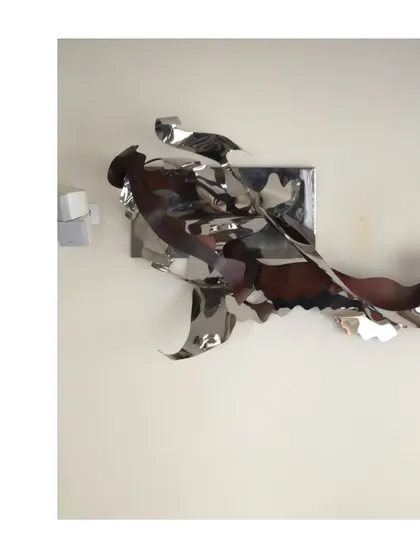 A 12-foot long abstract art installation from 2017, made of flowing, ribbon-like forms of stainless steel.