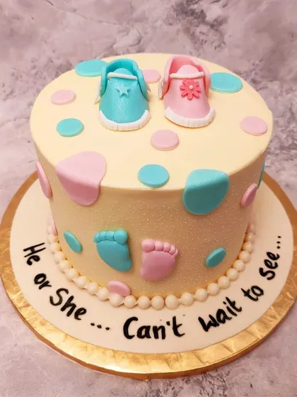 We keep the suspense with this cute "He or She" baby shower cake. Tiny blue and pink footprints and polka dots decorate the cake, leaving everyone guessing until the first slice is cut.