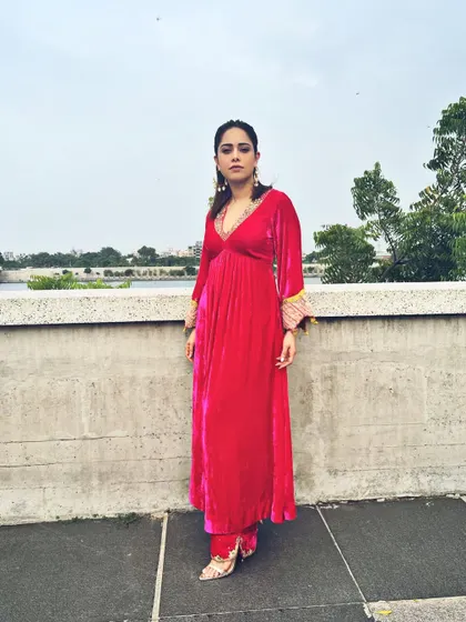 Another view of the pink velvet suit, showing how it stands out against the outdoor backdrop.