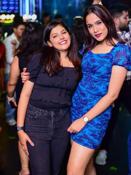Two friends enjoying the music and the vibe. It's great to see people connecting on the dance floor.