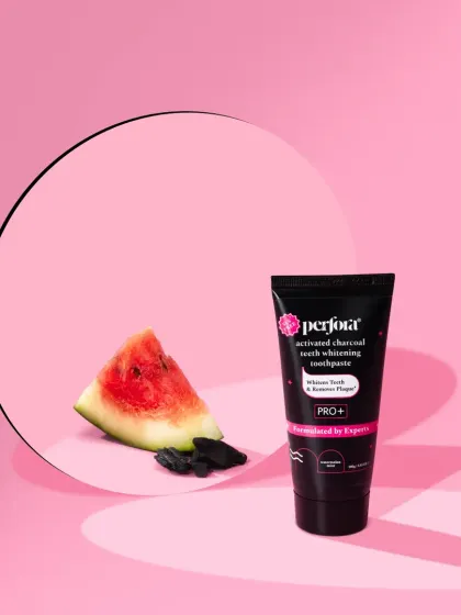 A conceptual shot for Perfora's activated charcoal toothpaste. The pink background provides a surprising contrast to the black product, while the watermelon slice hints at the flavor.