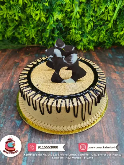 A beautiful chocolate drip cake with an abstract chocolate piece on top. The simple design highlights the rich flavour of the cake.