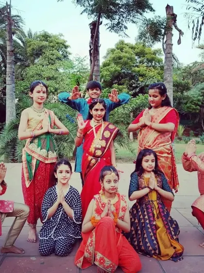 A beautiful group photo of our students in traditional Indian attire for a special performance.