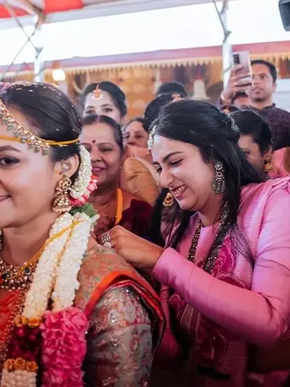 A close-up of the bride's happy expression, surrounded by the energy of her family and friends during the ceremony.