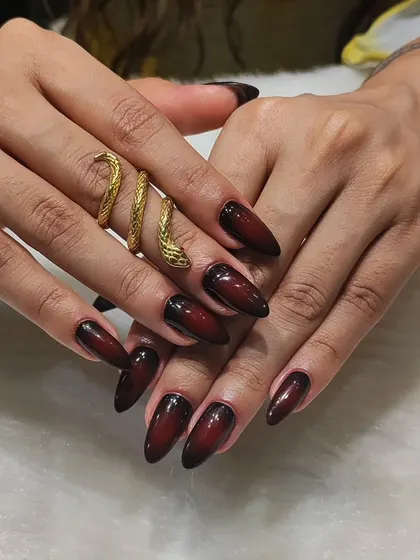 This look is all about dark, elegant drama. I created a seamless black-to-burgundy ombre effect on these long almond nails, finished with a high-gloss top coat for a sophisticated and edgy style.