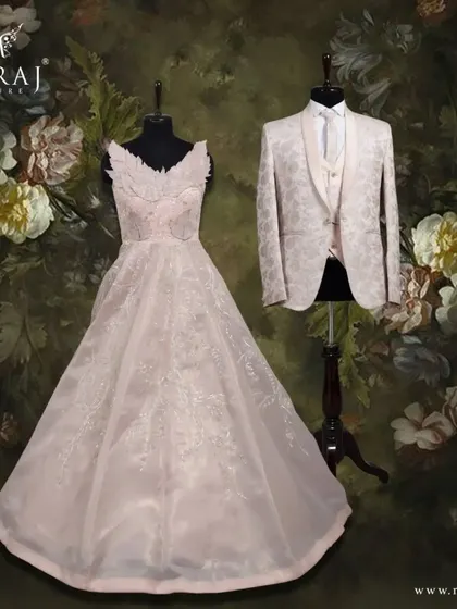 This coordinated look is all about soft elegance. The groom's peach suit, with its intricate texture, mirrors the delicate appliqué on the bride's designer neckline gown.