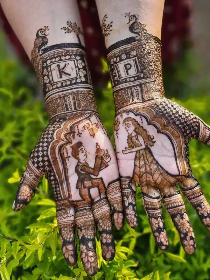 Your love story can be the centerpiece of your bridal henna. This design captures a beautiful proposal moment, complete with the couple's initials 'K' and 'P' framed by elegant peacocks.