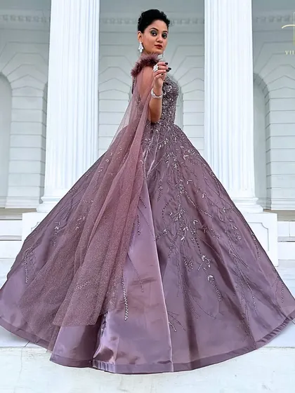A full-length shot of the mauve gown, capturing its impressive volume and elegant drape.