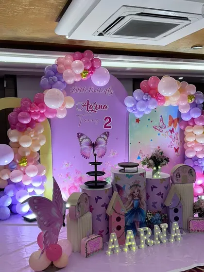 Another angle of the enchanting butterfly party decor, highlighting the layered backdrops and full balloon arches that create a sense of depth and wonder.