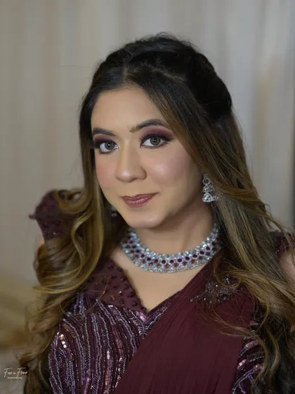 A final look at this maroon-themed cocktail glam. The makeup enhances her features beautifully, proving that with the right techniques, you can create a show-stopping look yourself.