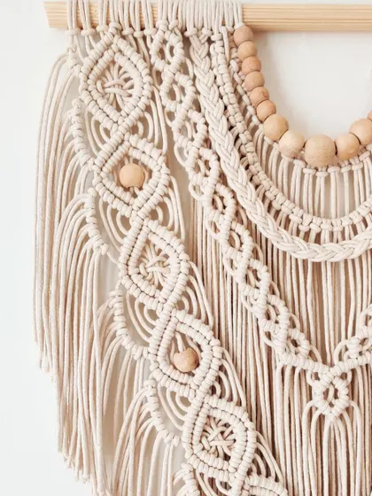 Another detailed shot of the intricate patterns in this beautiful, natural-colored wall hanging.