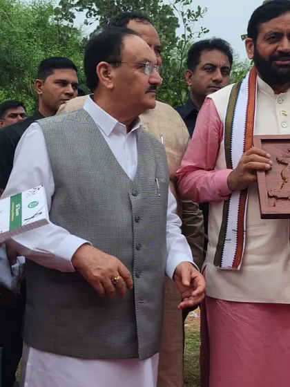 Our team presents a handcrafted wooden plaque to the dignitaries, a token of appreciation for their support of our green initiatives.