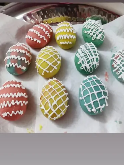 For Easter, I made these colorful egg-shaped treats. They are decorated with a white chocolate drizzle, making them a festive and fun dessert for the holiday.