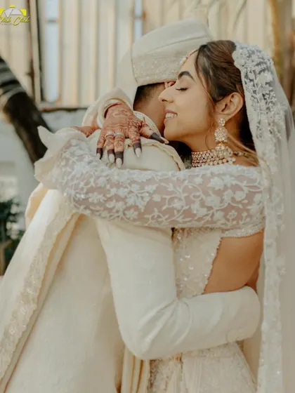 A heartfelt hug between the bride and groom after their first look. This image is full of emotion and love, a beautiful, candid moment of connection on their wedding day.