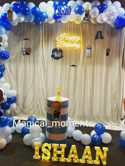 A Boss Baby theme with a white curtain backdrop and a 'Happy Birthday' neon sign, creating a clean and classic look.