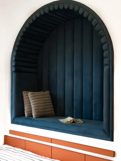 Another view of the cozy arched reading nook, showing how it's built into the wall to save space while creating a unique architectural feature.