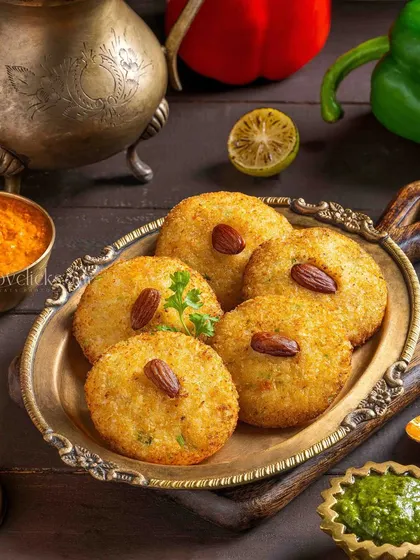 Dahi almond tikki, a unique appetizer, styled with antique props to create a rustic and traditional ambiance.