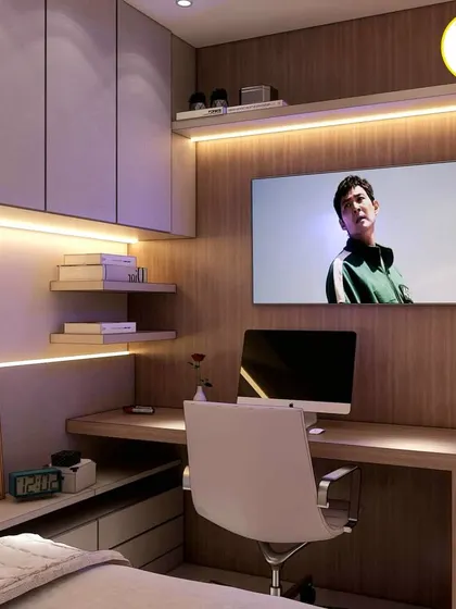 A close-up of the study desk in the compact room, showing the wall-mounted TV that can double as a monitor.