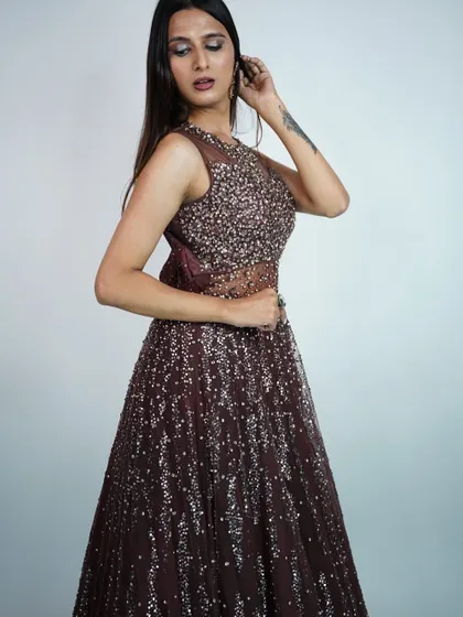 A full-length view of the brown sequined gown, showing how the sequins cascade down the skirt.