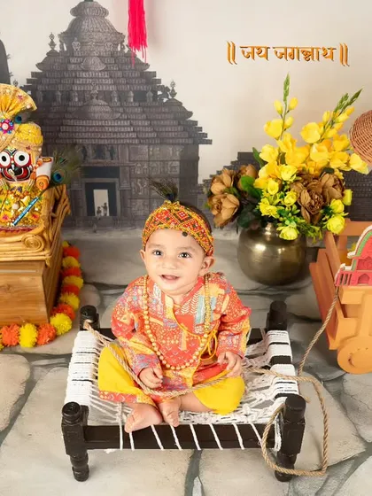 Celebrating our beautiful culture with a Rath Yatra theme. This little one is dressed in traditional attire, sitting before idols of Lord Jagannath, Balabhadra, and Subhadra.