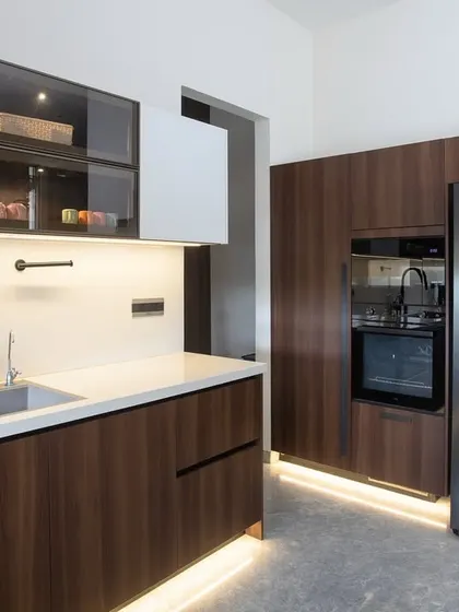 This shot highlights the integrated wall oven and refrigerator, showcasing how appliances can be seamlessly blended into the cabinetry for a clean, high-end look.